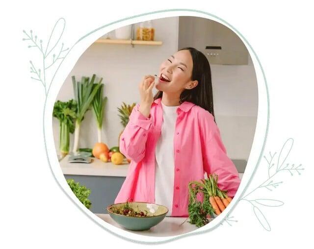 A woman joyfully eating fresh food.